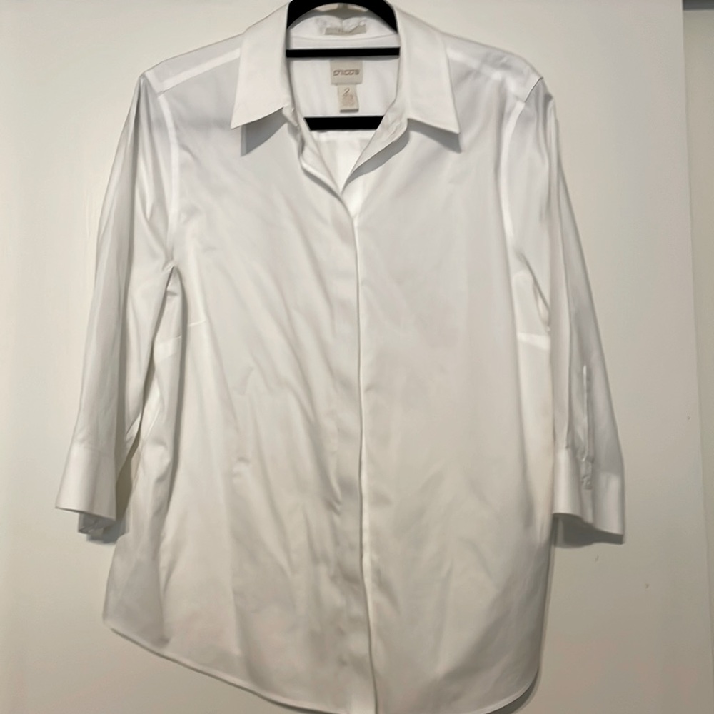 Chicos size 2 white button down no iron shirt, also buttons down back.